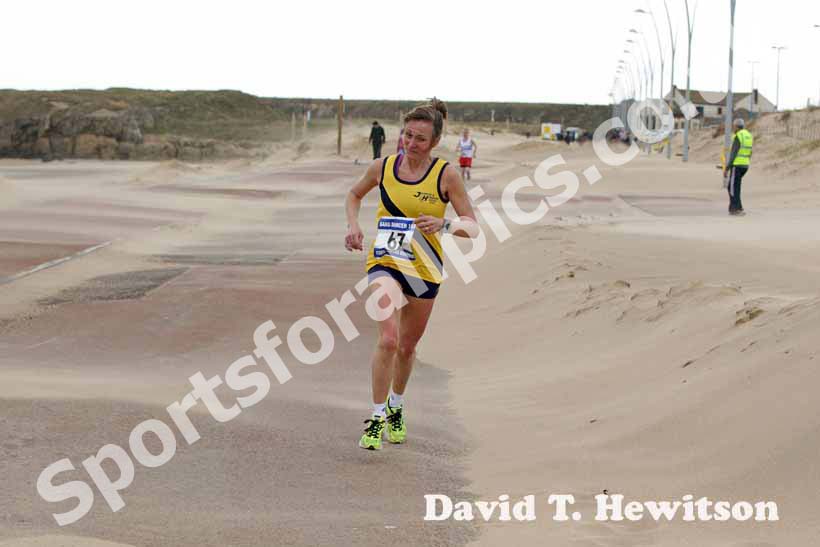 Elaine Leslie (Jarrow) battles her way through the wind and sand storm to win the womens Sand Dancer, South Shields.
